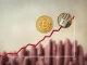 Bitcoin coins symbolizing a digital asset hedge against the backdrop of rising US National Debt, representing a safeguard against economic uncertainty.