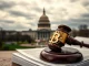 A gavel on legislative documents, symbolizing the US House's pivotal vote on the GENIUS stablecoin bill and broader crypto regulation.