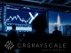 A digital screen displays the XRP logo and financial charts, symbolizing Grayscale's proposed XRP ETF filing and its potential market impact.