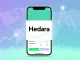 A dynamic illustration showing the Hedera HBAR logo on a mobile screen, representing its 7% surge after the HBAR Robinhood listing and increased crypto retail exposure.