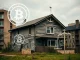 A digital overlay of tokens on a dilapidated house, symbolizing the RealT lawsuits and the risks of crypto fraud in tokenized real estate.