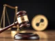 A gavel striking, symbolizing the historic conclusion of the SEC Ripple lawsuit, with XRP branding.