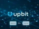 Upbit Story IP suspension for network upgrade, showing digital tokens paused for deposits and withdrawals.