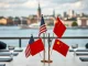 Diplomats at a table with US and China flags, representing the critical US-China trade talks in Stockholm impacting global markets.