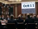 US Senate committee discussing digital asset taxation, with a blockchain graphic in the background, highlighting the upcoming crypto tax hearing.