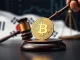 Gavel strikes a crypto coin, symbolizing South Korea crypto fines for market manipulation and illegal trading.