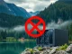 A 'No Entry' sign over a crypto mining rig in British Columbia, symbolizing the province's ban on new crypto mining operations.