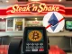 Steak 'n Shake logo next to a Bitcoin symbol, illustrating the fast-food chain's decision to stick with Bitcoin and scrap ETH payments.