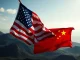 A symbolic image depicting the US-China trade war, showing two national flags clashing, representing the ongoing economic conflict and trade tensions.