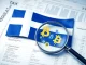 Finnish flag and crypto icons symbolizing new Finland crypto tax reporting regulations.