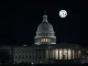 The US Capitol building illuminated at night, symbolizing the crucial US House vote to resolve the federal funding crisis.