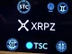 A digital screen showing the **XRP ETF** ticker XRPZ, symbolizing Franklin Templeton's DTCC listing and its potential market impact.