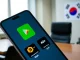Smartphone showing unregistered crypto exchange apps like Binance on Google Play despite South Korea's FIU delisting plan.