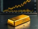 Gold bullion bar with chart showing gold price breaking record highs above $5,400.