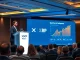 Ripple CEO Brad Garlinghouse presenting 2025 strategy for XRP and RLUSD growth at fintech conference