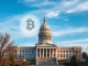 South Dakota State Capitol with Bitcoin symbol representing the HB 1155 bill for institutional cryptocurrency investment.