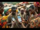 People in an African market using smartphones for stablecoin transactions to combat inflation and high remittance costs.