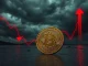A cracked Bitcoin coin representing $2.3 billion in realized losses during market capitulation.