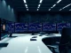 BlackRock IBIT Bitcoin ETF shows minimal redemption during Bitcoin price volatility on trading desk monitors.