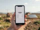 Conceptual image of a stablecoin digital wallet interface overlaid on scenes of infrastructure rebuilding in Gaza.