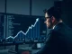 Investigator analyzing blockchain data showing crypto trafficking flows linked to illicit networks.