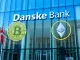 Danske Bank headquarters with Bitcoin and Ethereum symbols, representing its new crypto ETP policy.