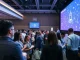 Audience at a major blockchain conference discussing industry trends and technology.