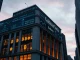 Goldman Sachs building with crypto charts overlay representing $2.3 billion spot ETF exposure.