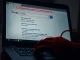 A laptop screen shows a dangerous Google ad scam targeting DeFi traders with a fake Uniswap interface.