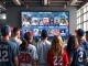 MLB NFTs displayed on a digital screen as fans engage with new digital collectibles and experiences at a baseball stadium.