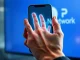 Pi Network palm print authentication system on smartphone for enhanced security before token release.