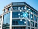 UBS headquarters with a digital overlay representing its cautious crypto and tokenization strategy for private banking.