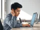 Office worker experiencing AI brain fry with mental strain at desk