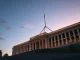Australian Parliament building with digital finance overlay representing crypto licensing bill.