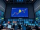 A bank trading floor with Bitcoin and traditional market data displayed on screens.