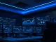 Analyst monitors cryptocurrency and AI project dashboards on trading desk screens.