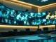ByteDance office monitors showing AI-generated video clips amid legal documents.