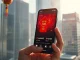 Smartphone displaying a digital yuan red envelope over a crypto trading chart, symbolizing the convergence of traditional finance and digital assets during Chinese New Year 2026.
