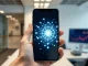 Smartphone displaying a blockchain network, symbolizing the tension between crypto mass adoption and its original decentralized ideals.