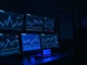 Analyst monitors Ethereum blockchain data and on-chain metrics on trading desk screens.