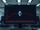 Ethereum price chart showing a decline below the $2,000 support level on a trader's monitor.