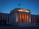 Federal Reserve building with blockchain visualization representing Kraken's master account approval and crypto policy shift