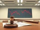 Legal gavel on action documents with declining stock graph representing the Gemini lawsuit.