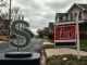 Political conflict between a Central Bank Digital Currency symbol and a For Sale sign representing the threatened housing affordability bill.