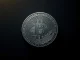 Damaged cryptocurrency token representing security breaches and value loss after hacks