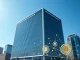 National Bank of Kazakhstan headquarters with digital asset visualization representing the $350 million crypto-linked portfolio investment.