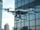 Lucid Bots Sherpa drone cleaning the window of a commercial high-rise building.