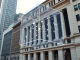 NYSE building with blockchain network visualization representing the new tokenized securities platform partnership.