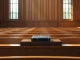 Legal and cryptocurrency symbols clash, representing the OCC crypto bank charter lawsuit considered by major US banks.