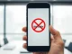 OpenAI Sora app shutdown depicted on a smartphone screen with closure symbol.